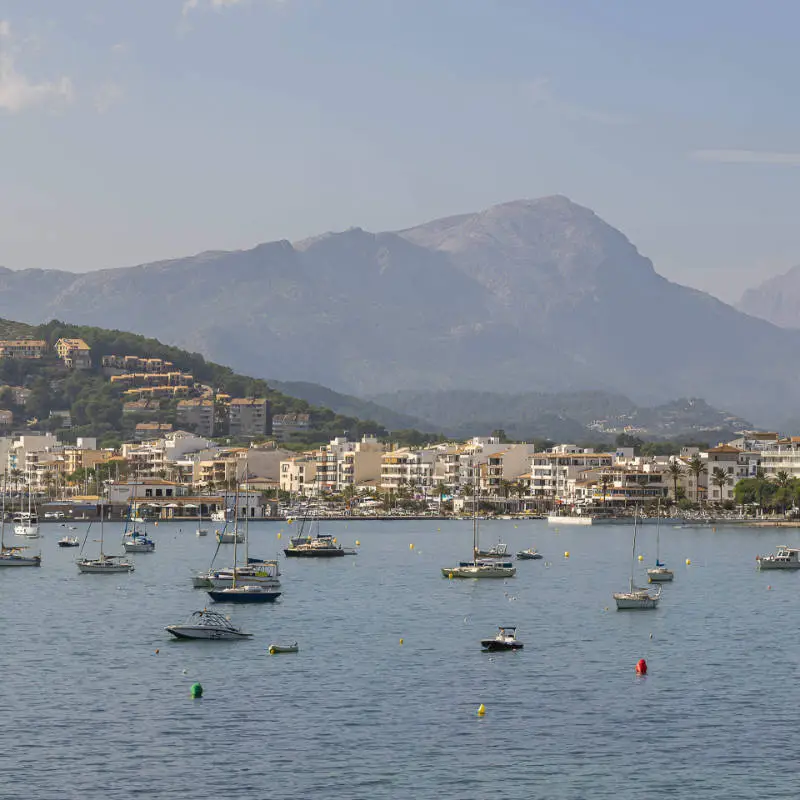 Puerto Pollensa bay with boats and the Tramuntana mountains in the background